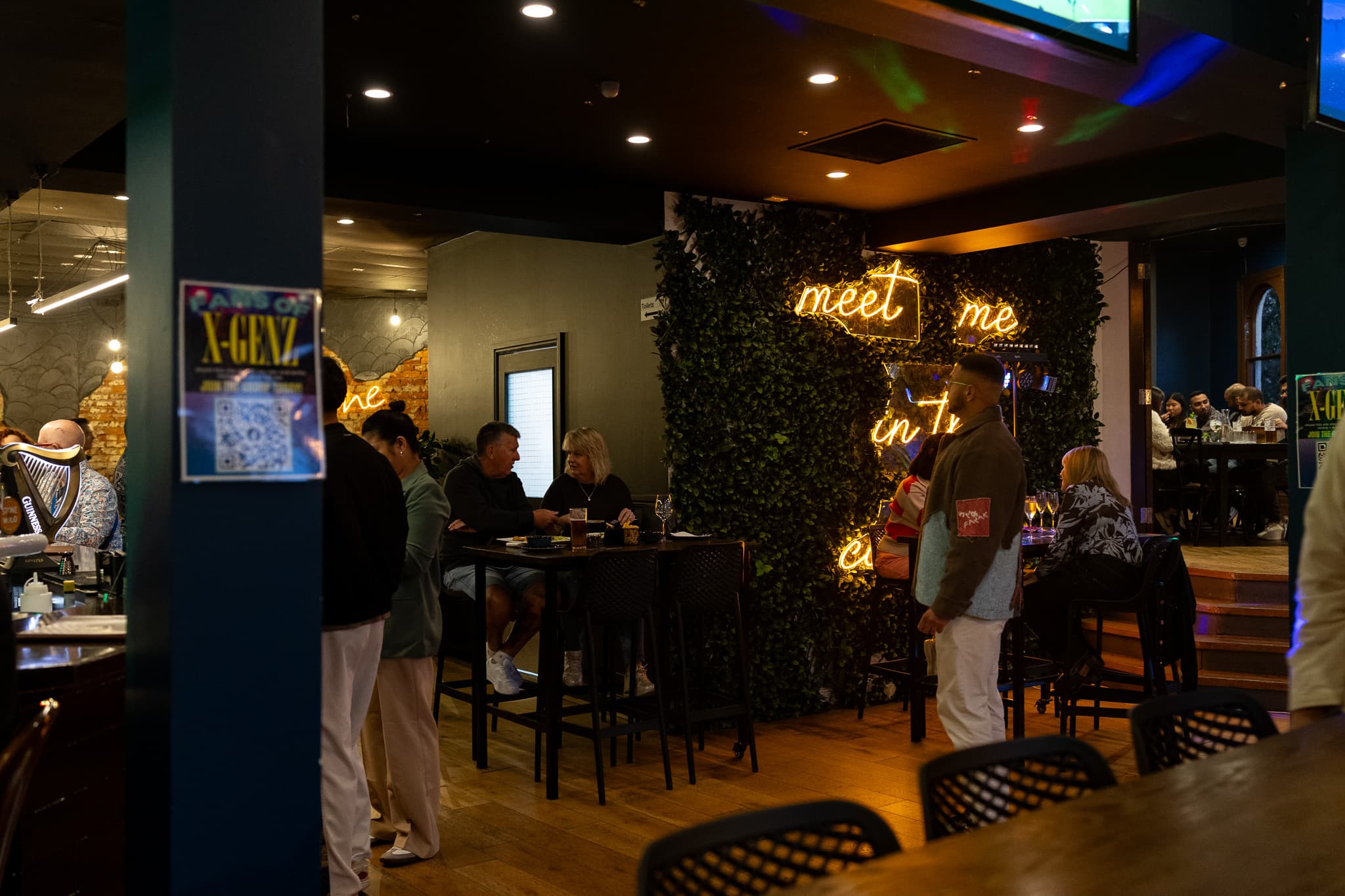 Guests gathering inside The Cornerstone Pub