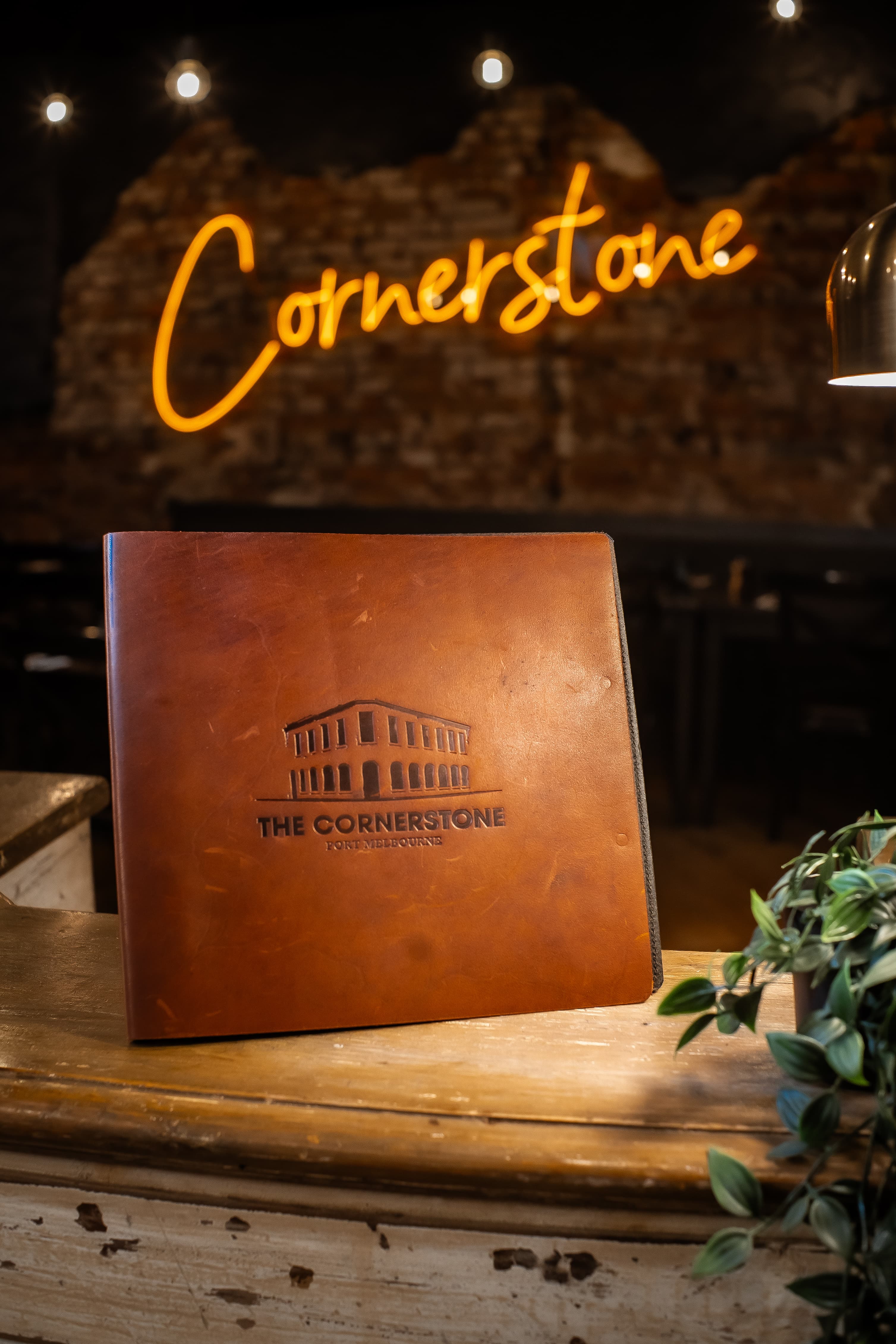 The Cornerstone menu and illuminated venue sign
